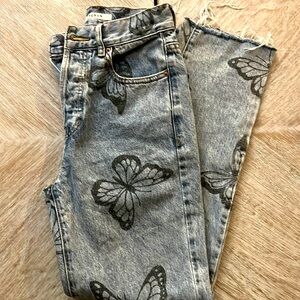 Blue light wash butterfly print jeans.